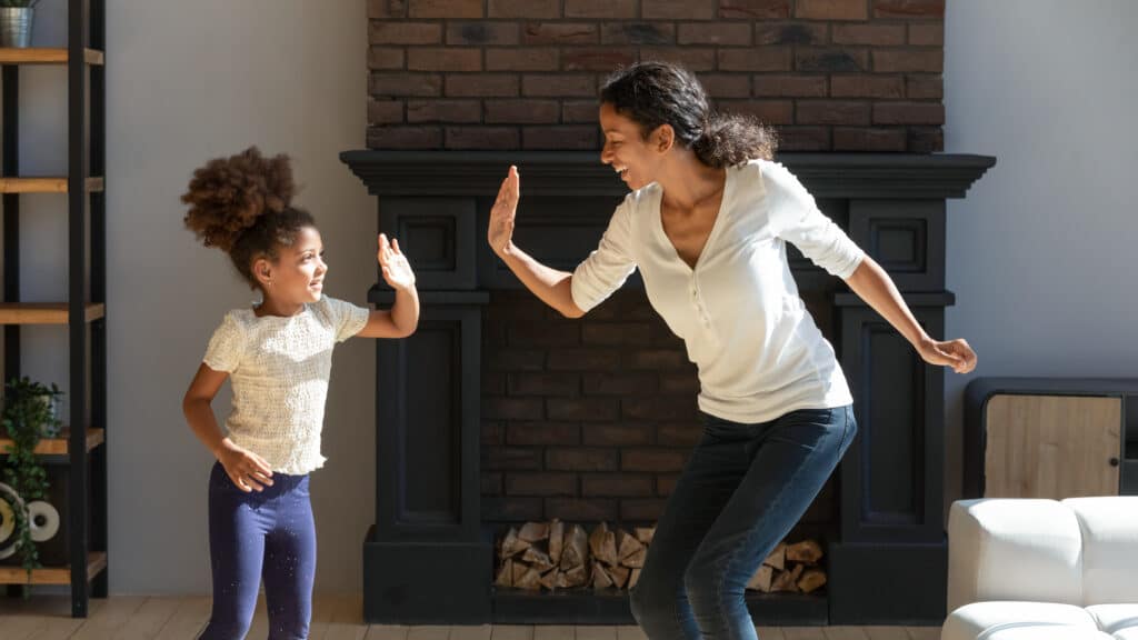 In-Home Child Care Professional Shares a High-Five with a Child