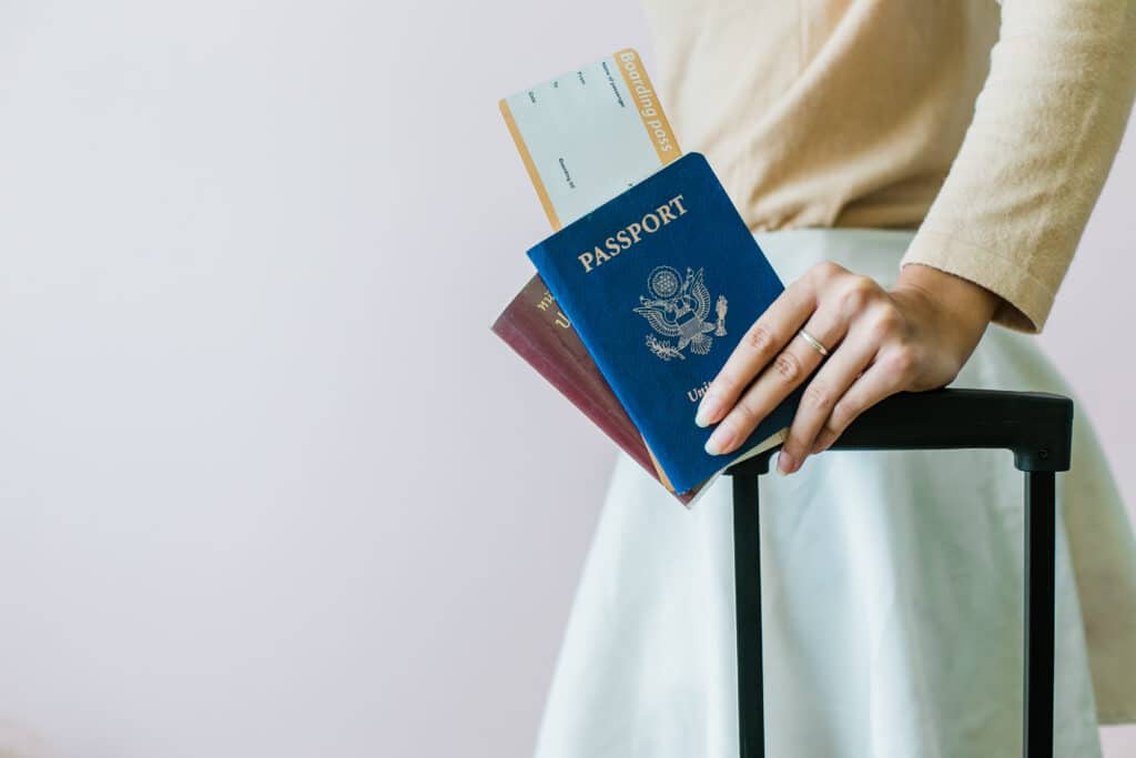 Closeup of a Woman's Hand Holding a Passport and Boarding Pass