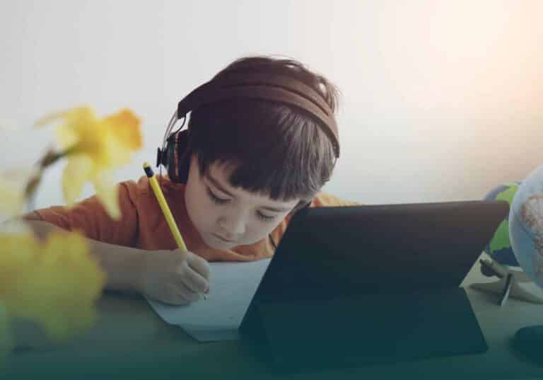 Boy with headphones doing homework