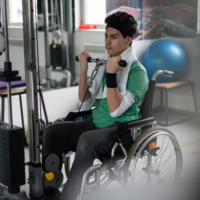 Disabled Teenage Boy in Wheelchair Having Gym Training