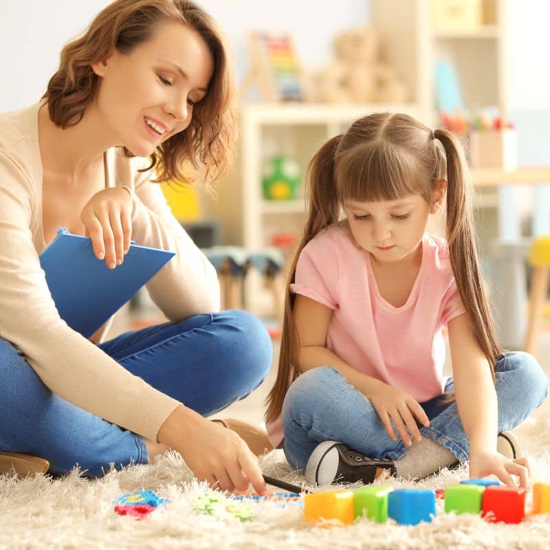 a therapist playing together with a child