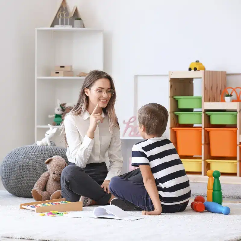 A speech therapist teaching a boy